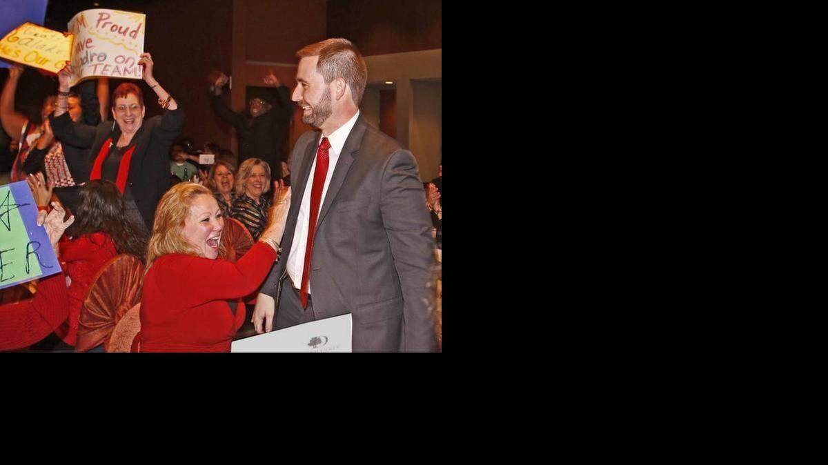 
Teacher of the Year Geoffrey Aladro is congratulated by fellow teachers as he makes his way to the stage on Thursday. 
