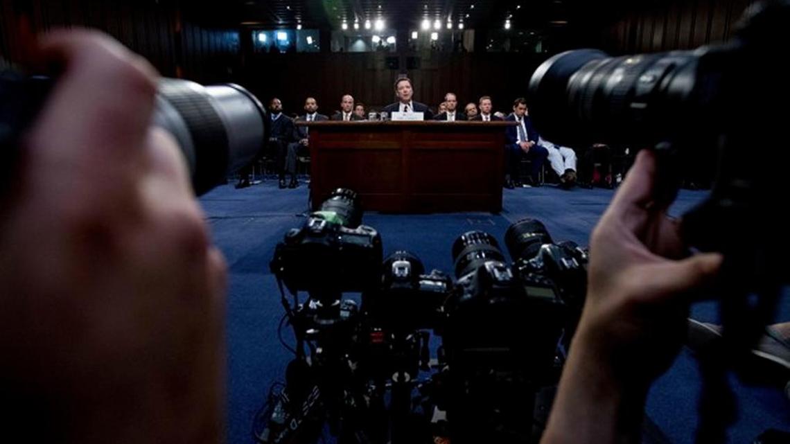 Photographers snap away as former FBI Director James Comey testifies Thursday in Congress.