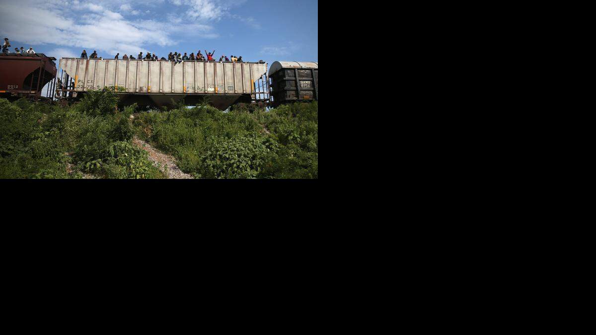 
Thousands of migrants ride atop the trains, known as La Bestia, or The Beast, during their long and perilous journey from Central America through Mexico to the U.S. 
