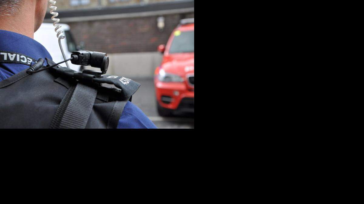 
Police officer wears a shoulder-mounted camera.
