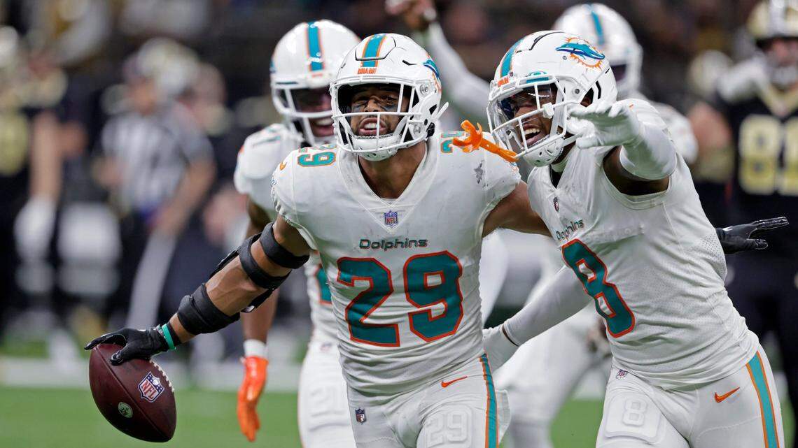 Miami Dolphins safety Brandon Jones (29) celebrates with Jevon Holland (8) after intercepting a pass against the New Orleans Saints during the second half of an NFL football game Monday, Dec. 27, 2021, in New Orleans. The Dolphins won 20-3. (AP Photo/Butch Dill)