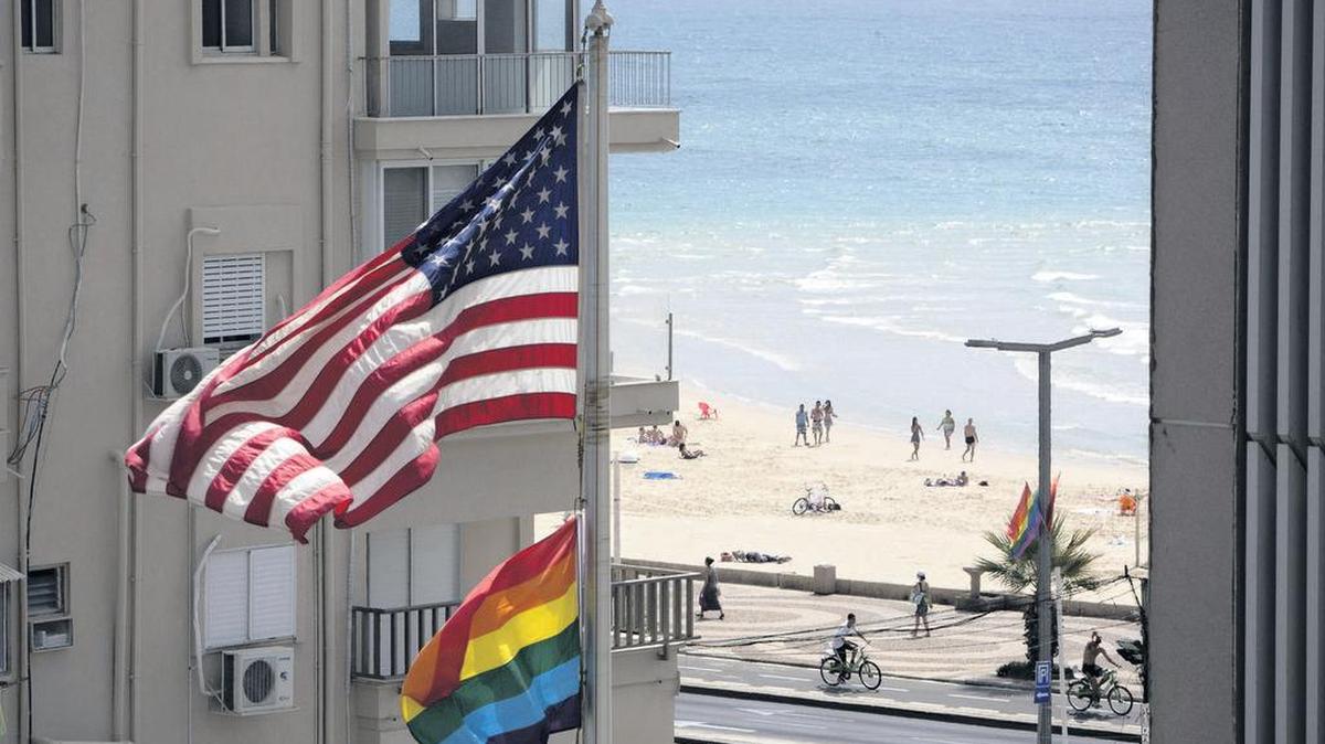 A United States flag flies alongside a Pride flag at the U.S. Embassy in Tel Aviv in 2014.