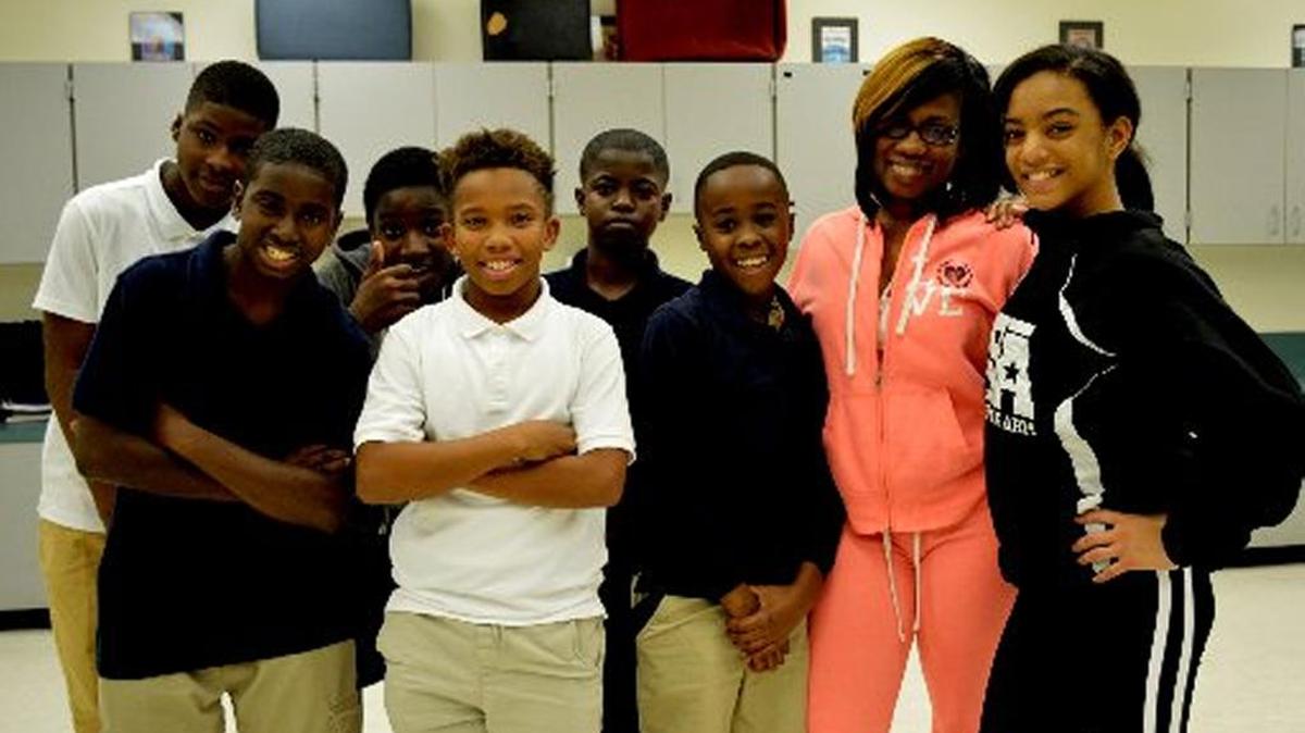 Tanisha Cidel, second from right, who teaches in the theater magnet program at Norland Middle School, with students.