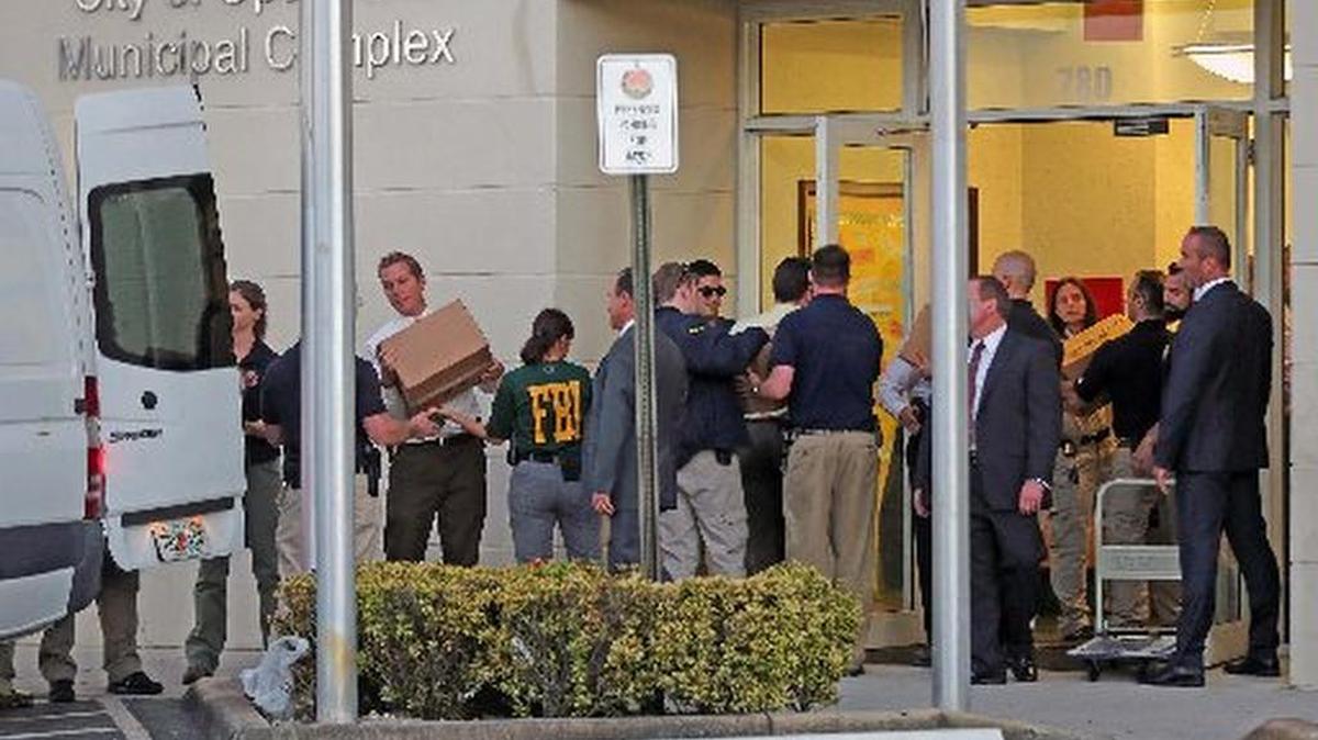 FBI agents remove boxes of documents as evidence from Opa-locka’s Municipal Complex building.