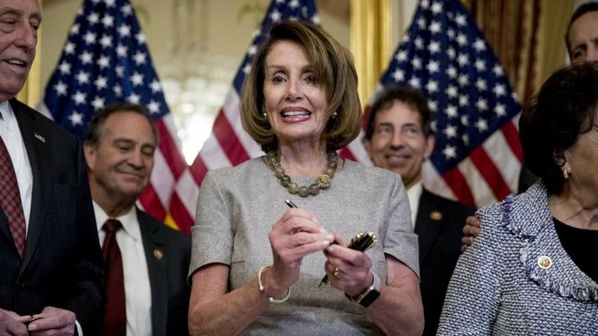 House Speaker Nancy Pelosi accompanied by House Democratic members stand after signs a deal to reopen the government on Friday.