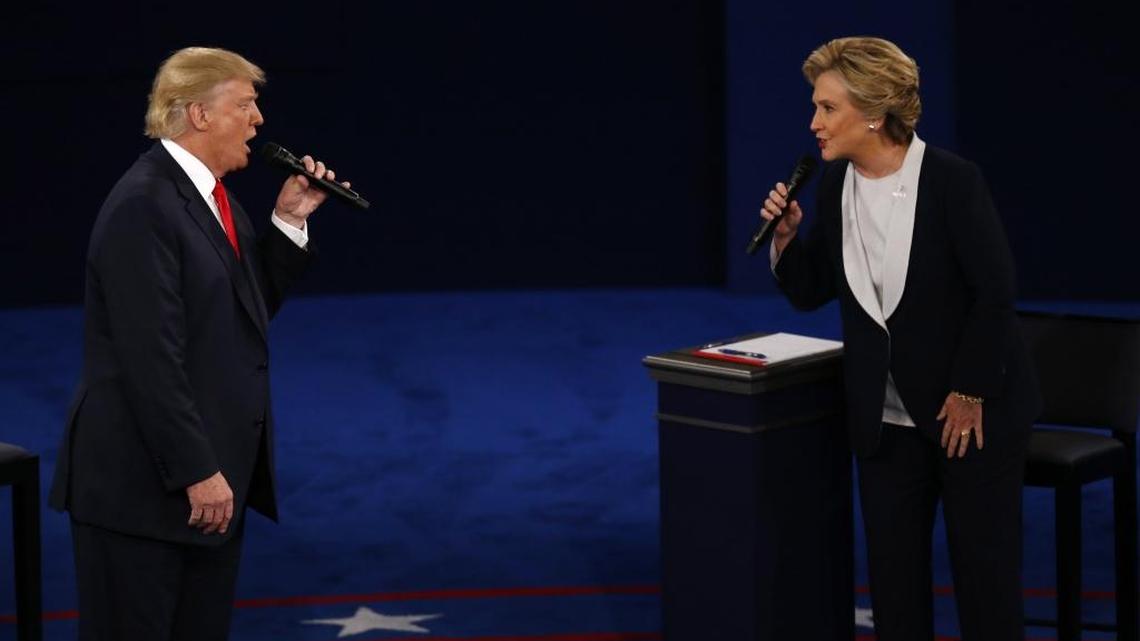 Donald Trump and Hillary Clinton confront each other during the second presidential debate in St. Louis, Missouri.