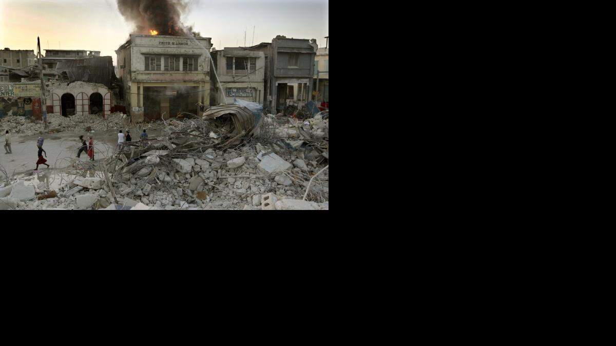 
FILE ART: Earthquake aftermath:The store NaNou on Jean Jacques Dessalines street burns in downtown Port-Au-Prince on Jan. 22, 2010.


