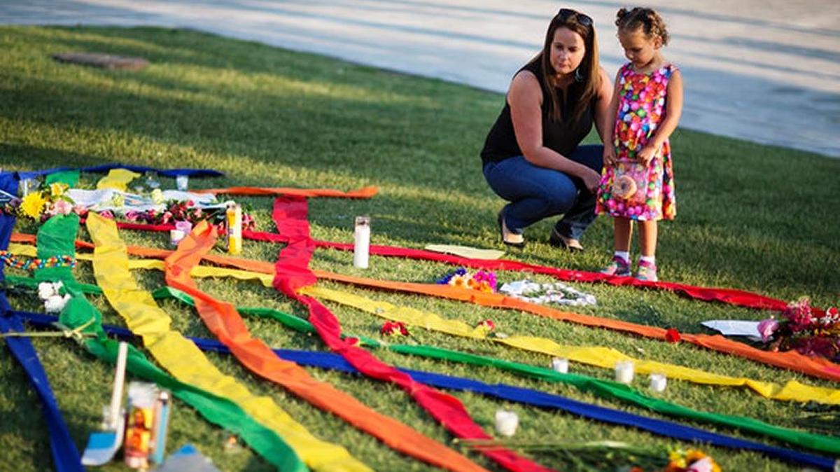 Rhonda Rodeffer, left, and daughter Kennedy, 4, visit a makeshift memorial for victims of the Orlando shooting.