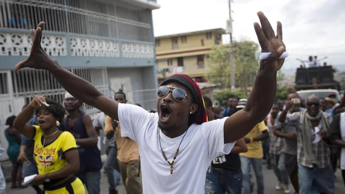 Demonstrator chants “Down with Martelly” during a protest against President Martelly’s government in Port-au-Prince last week.