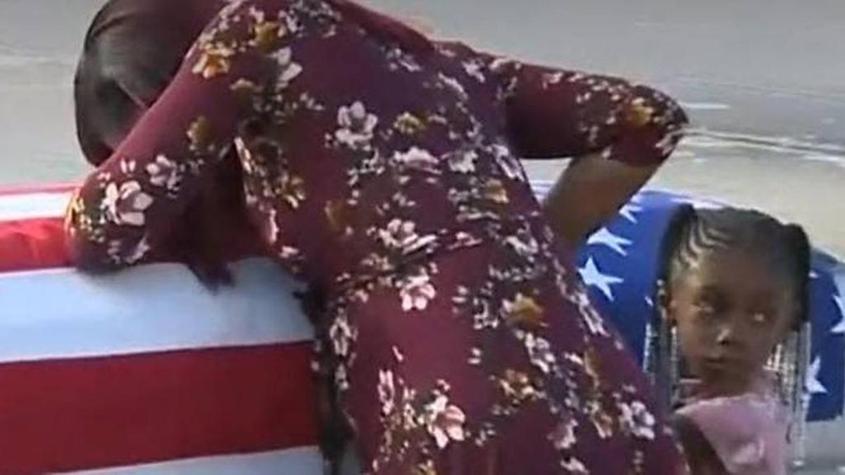Myeshia Johnson grieves at her husband’s coffin at MIA.