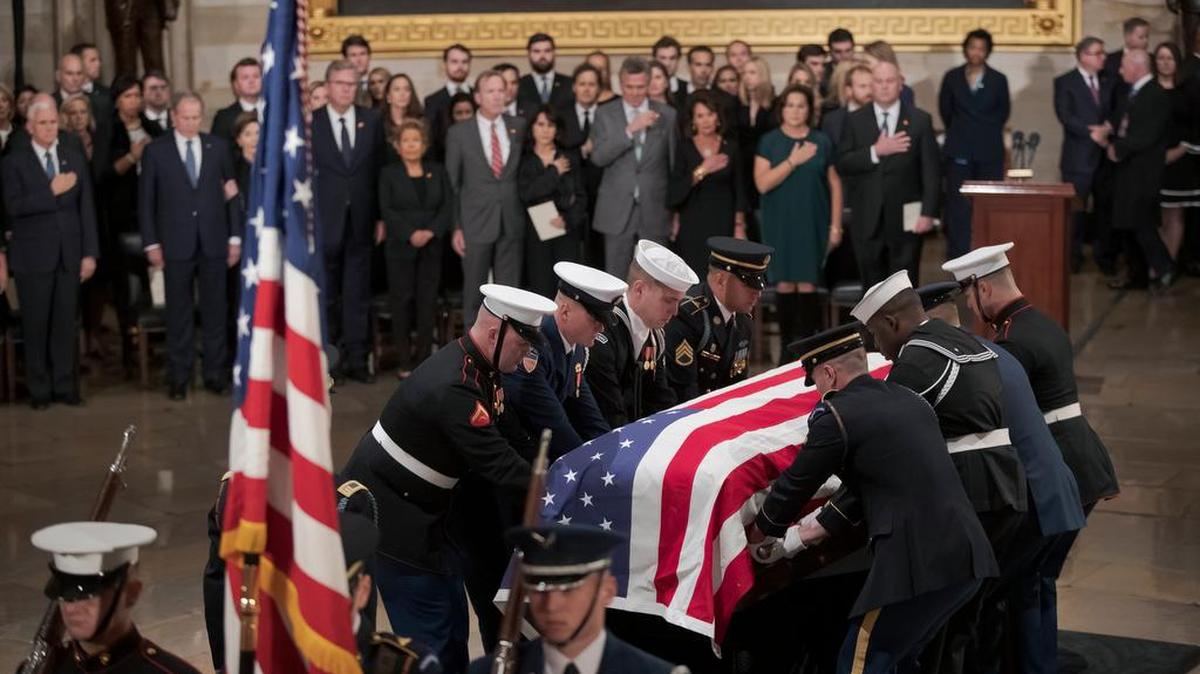 The flag-draped casket of former President George H.W. Bush is carried into the Capitol Rotunda on Monday.