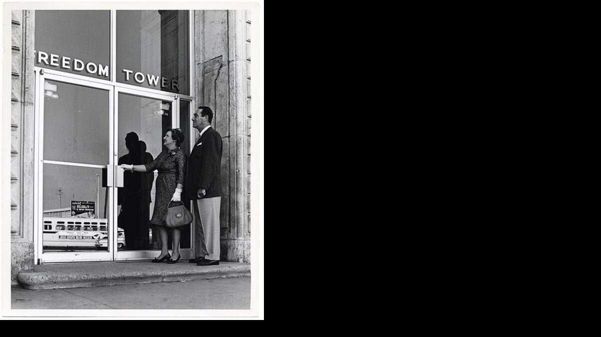 
A couple stands at the door of the Freedom Tower in downtown Miami, the first stop for many Cuban exiles.
