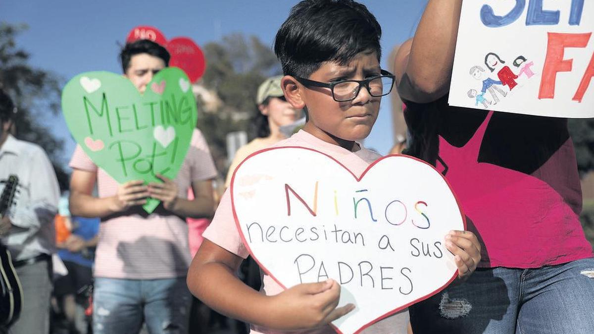 Boy with a sign that says: “Children need their parents” at a protest against Trump administration’s family separation policies.