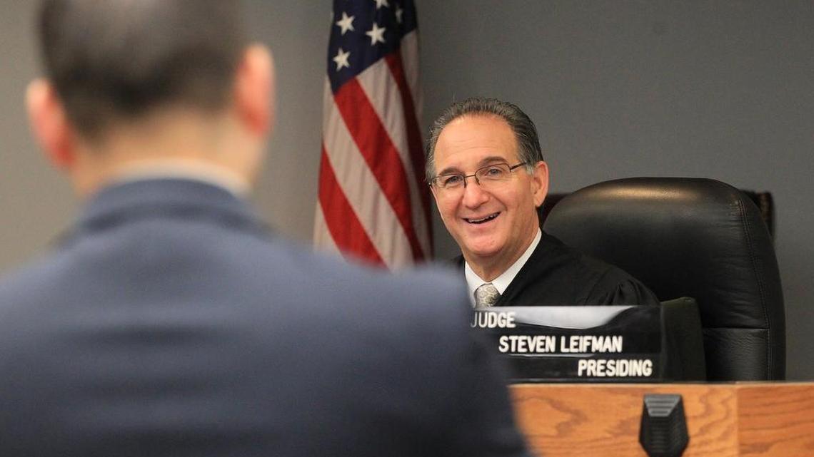 Judge Steve Leifman, speaking with an attorney in his courtroom, created the Criminal Mental Health Program. The New England Journal of Medicine has held it up as a model for other large cities struggling with the revolving door of mentally ill people.