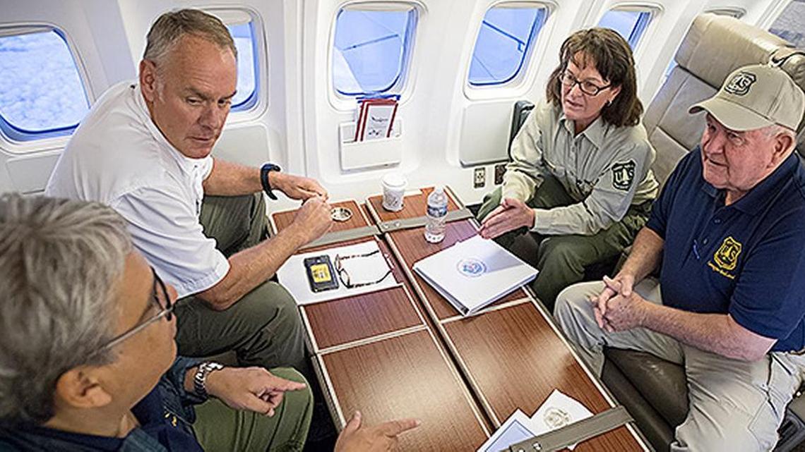 Interior Secretary Ryan Zinke (top left) recently received a briefing about wildfires while onboard a private jet.