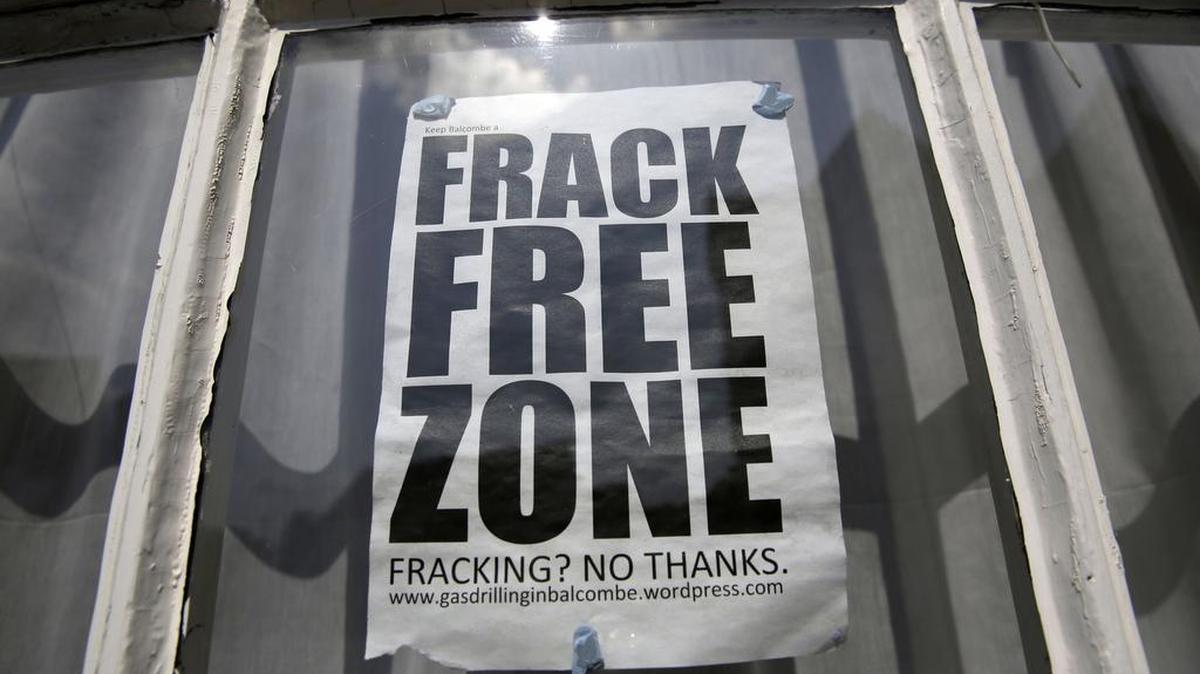An anti-fracking protest sign sits in the window of a residential property in Balcombe, West Sussex in the United Kingdom.