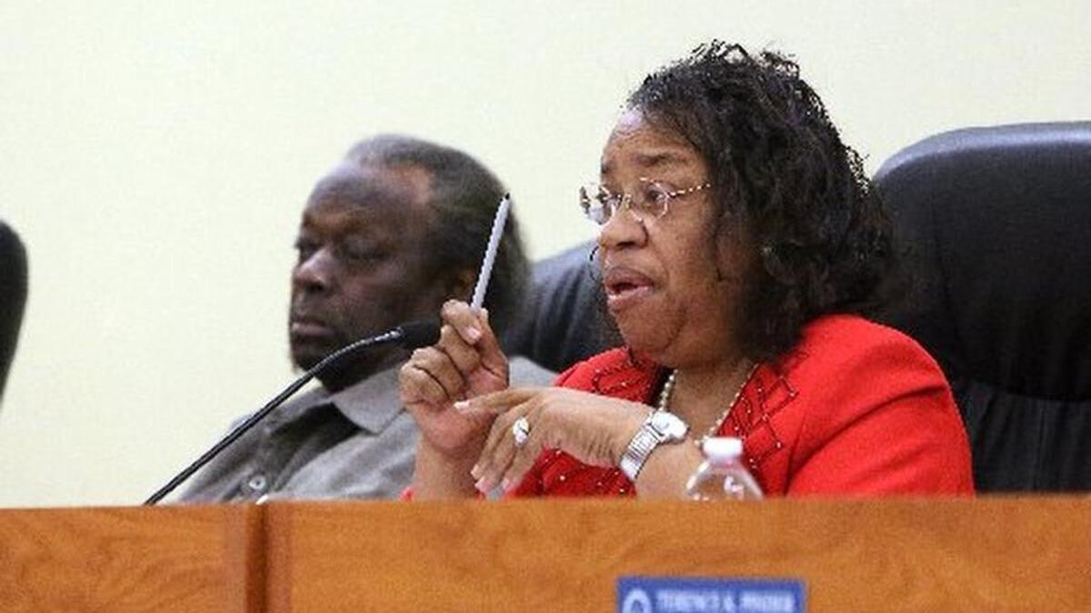 Mayor Myra L. Taylor, on the dais with Vice Mayor Timothy Holmes, at a special meeting where the city manager was fired.