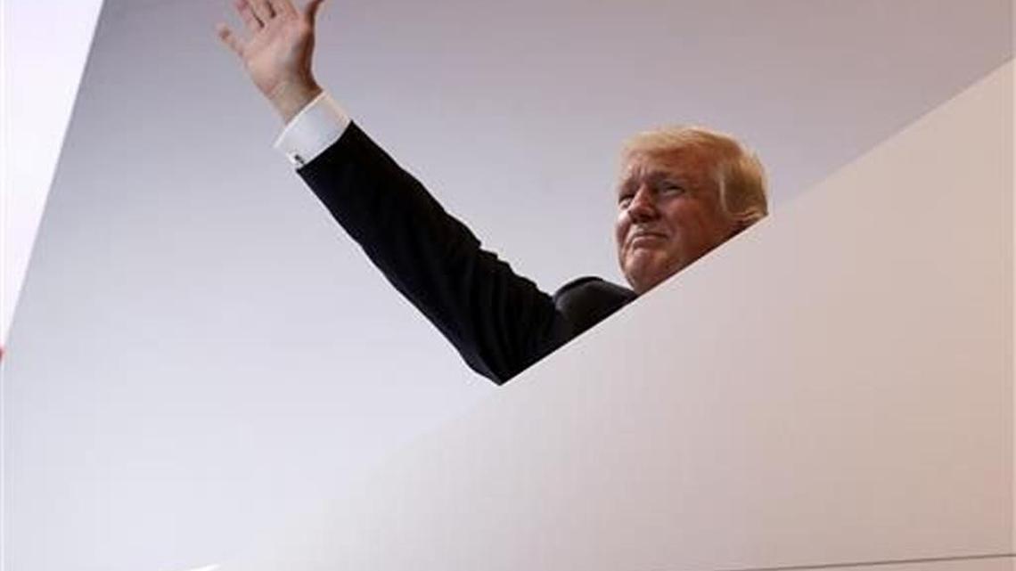 Donald Trump waves as he leaves the convention stage on Monday.