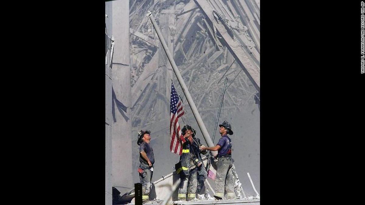 Firefighters raise the American flag at Ground Zero in New York after the terror attacks of Sept. 11, 2001.