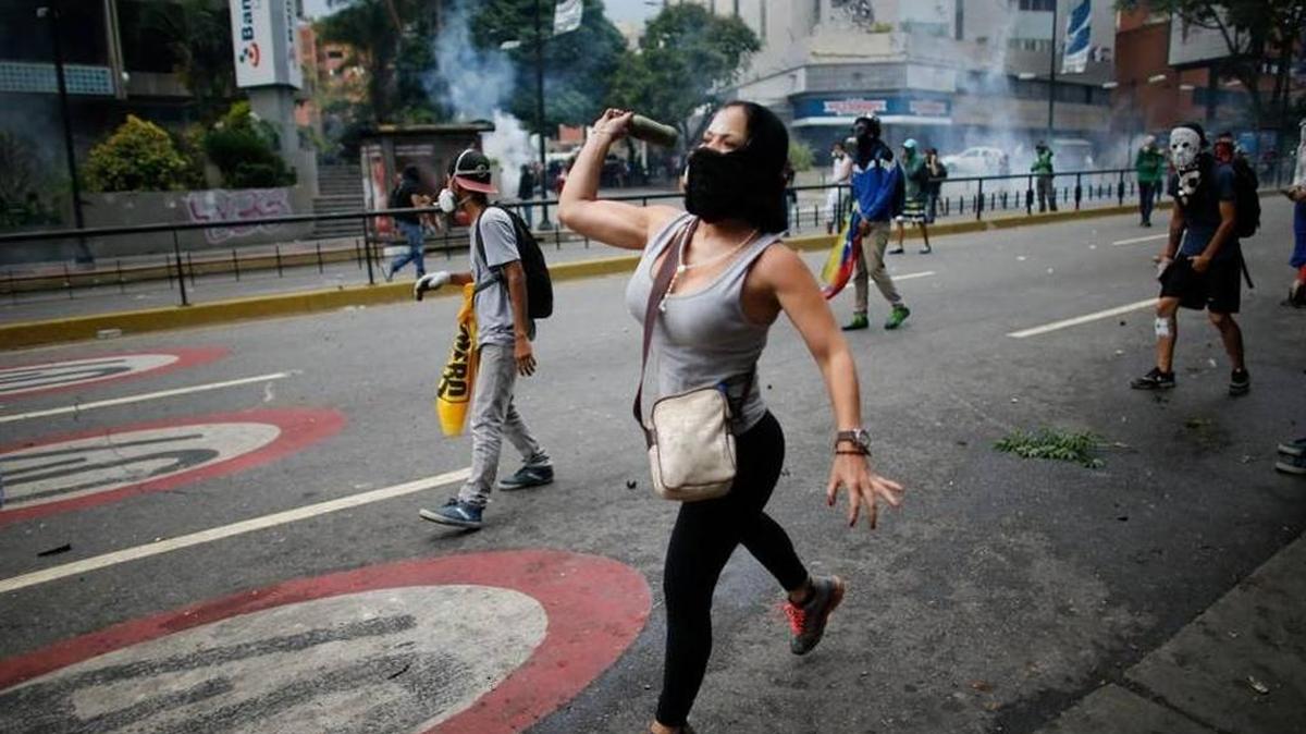 A protester throws a bottle during an anti-government demonstration in Caracas.