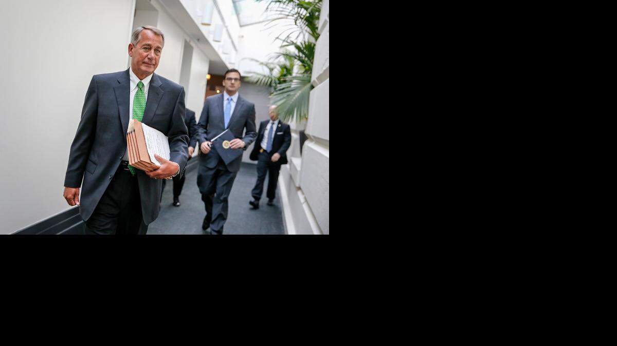 
IN CHARGE: House Speaker John Boehner walks to a closed-door meeting with House Republicans on Wednesday.
