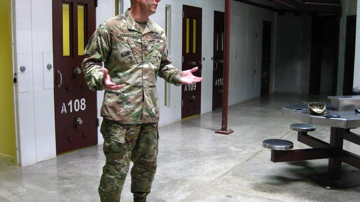Army Col. Steve Gabavics, the new guard force commander at Guantánamo, briefs reporters in an empty cellblock in July.