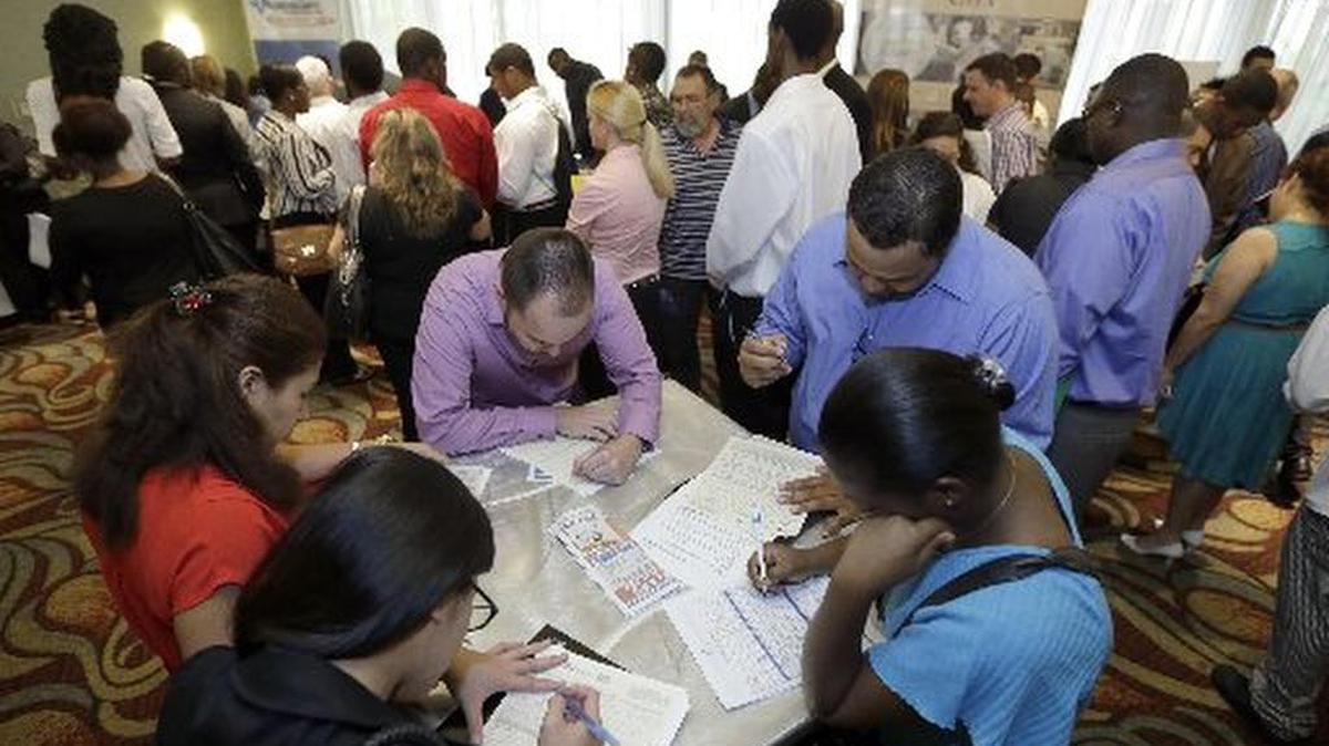 
Residents look for work at a jobs fair last year in Miami Lakes. 
