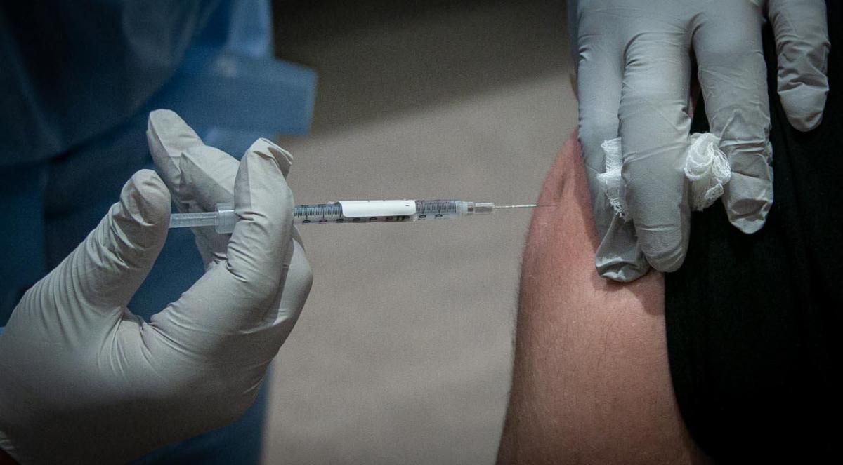 David Lindsey, an ICU nurse at Baptist Hospital, gets his vaccine when Baptist Health began administering the first COVID-19 vaccines for its front-line healthcare workers.