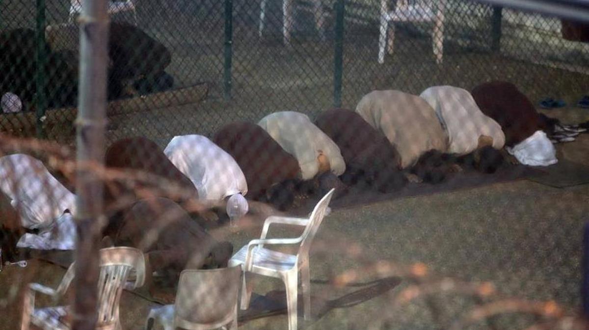 
Praying in detention: War on terror suspects held at Guantánamo Naval Base shown here praying during Ramadan in July.
