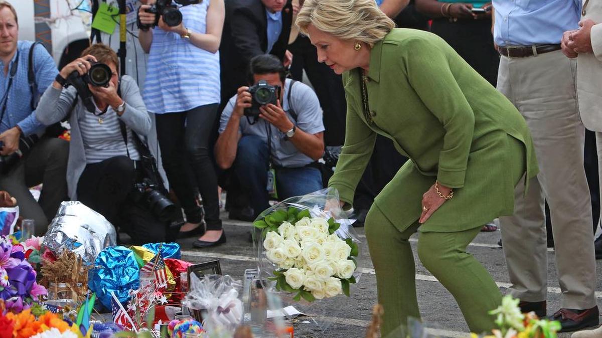Hillary Clinton leaves flowers on a memorial outside of the Pulse nightclub in Orlando on Friday.