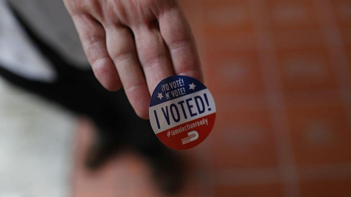 A Miami voter shows off his sticker after casting a ballot in 2016.