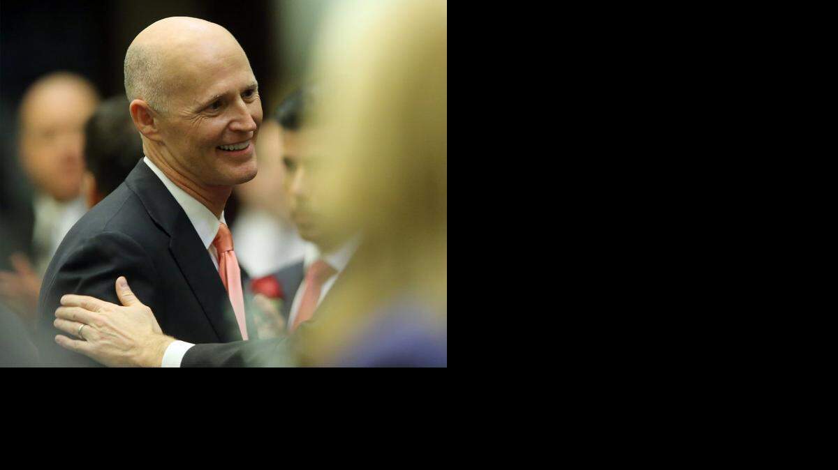 
Gov. Rick Scott is congratulated Tuesday after his State of the State speech on the opening day of the Florida Legislature. 

