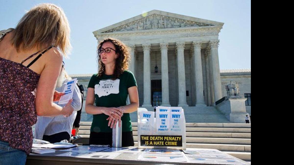 
Danielle Fulfs, 24, of Seattle, with the Washington Coalition to Abolish the Death Penalty, hands out materials about the death penalty outside of the Supreme Court in Washington on Monday. 


