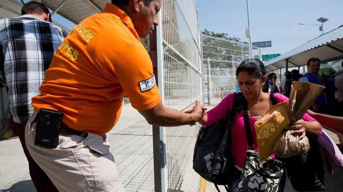 An immigration official in Mexico helps a Cuban woman who made it to the border of Guatemala and Mexico last week.