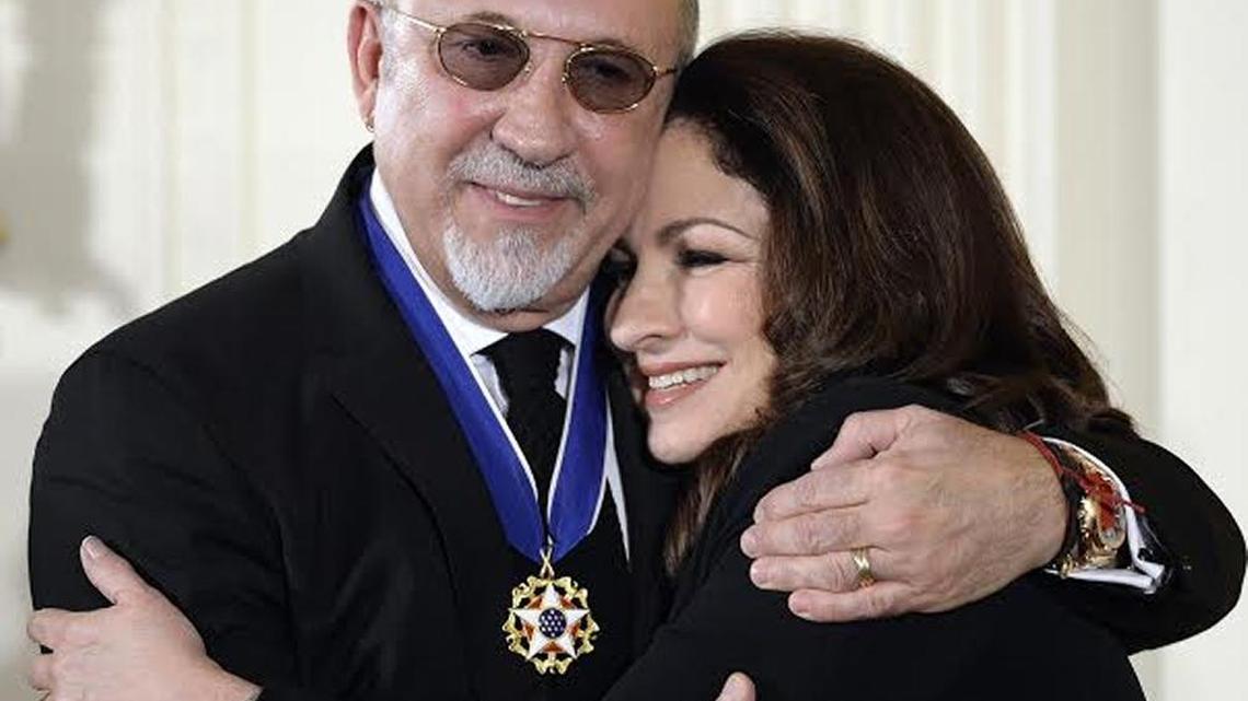 Singer Gloria Estefan and husband, music producer Emilio Estefan, warmly hug following the Presidential Medal of Freedom ceremony in the East Room of the White House.