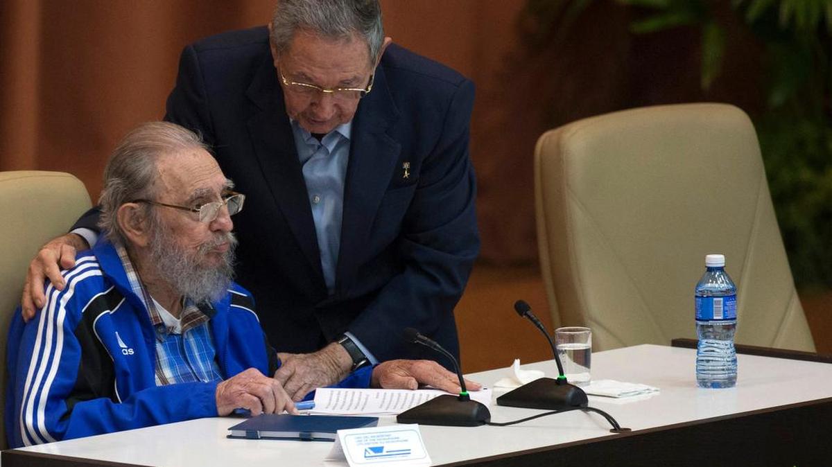 Cuban President Raúl Castro leans over to embrace his brother during a meeting of the Cuban Communist Party Congress.