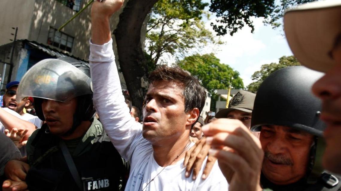 
Sentenced: In 2014, opposition leader Leopoldo Lopez was flanked by Bolivarian National Guards after he surrendered. 

