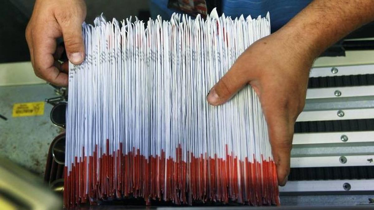 Julio Galligaris sorts through mailed-in ballots at the Miami-Dade Election Department.