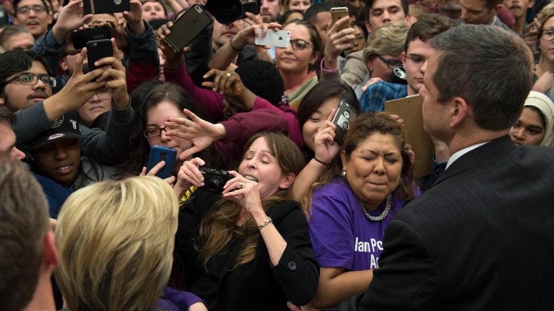Supporters scramble for a photo of Democratic presidential candidate Hillary Clinton after she spoke at a campaign event at George Mason University in Fairfax, Va.