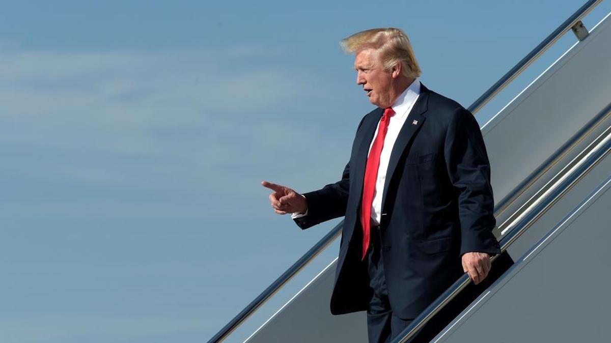 President Trump arrives a Palm Beach International Airport Friday, headed for Mar-a-Lago.