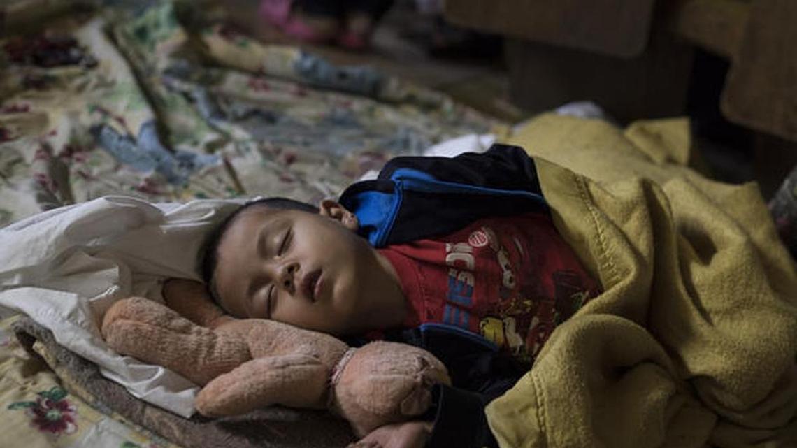 A Central American child who is traveling with a caravan of migrants on its way to the United States sleeps at a shelter in Tijuana, Mexico, in April.