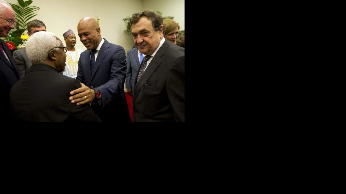 
URGING ACTION: Haitian President Michel Martelly, center, greets representatives of the United Nations Security Council in Port-au-Prince. Council members pressed Mr. Martelly to hold long-delayed elections.
