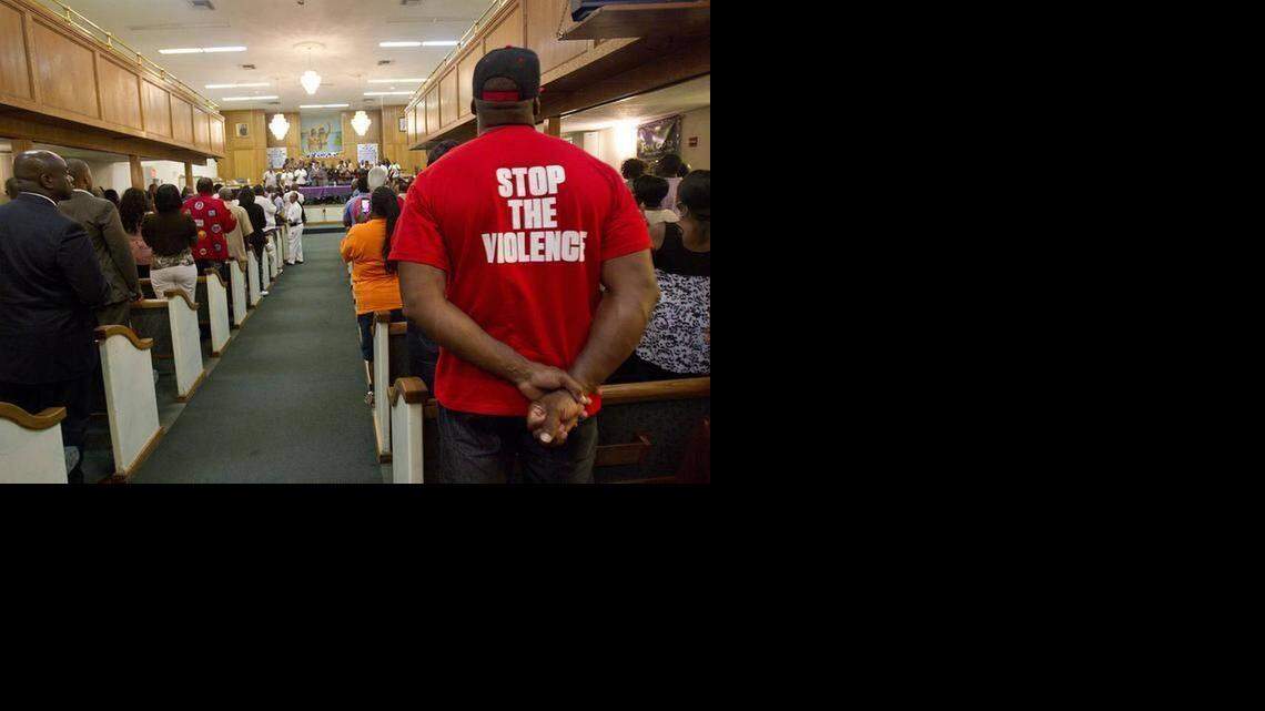 
A PLEA: Cornell Williams, right, wears a shirt expressing his concerns at Mount Calvary Baptist Church last year after a surge of shootings around the Liberty Square public-housing project.

