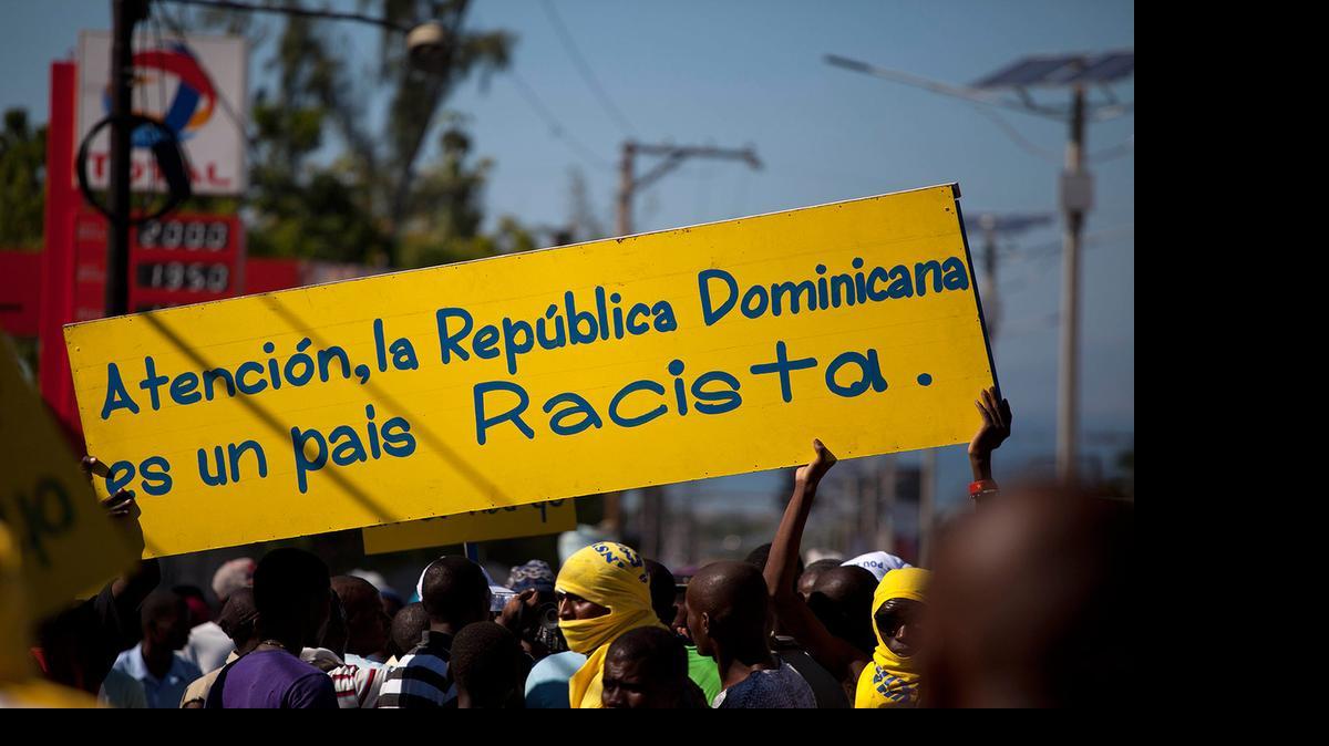 
IN 2013: Protesters hold a banner that reads in Spanish; “Attention, the Dominican Republic is a racist country,” in Port-au-Prince, Haiti,

