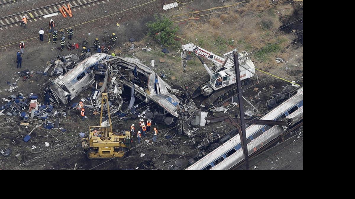 
MANGLED: Emergency workers at the scene of the deadly May 13 train accident in Philadelphia. Eight people died. 
