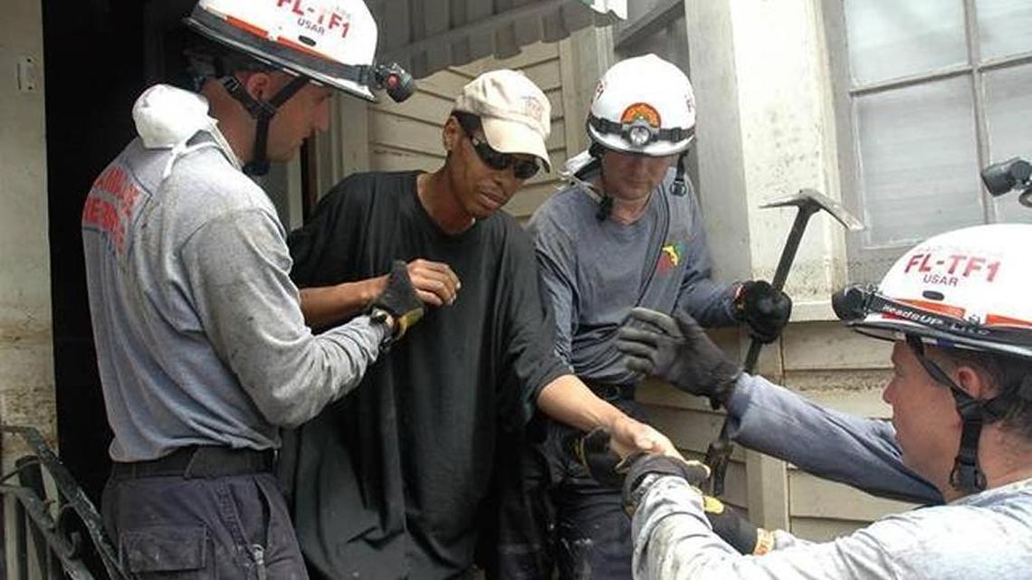 A rescue team that includes members from Miami-Dade County helps a man who was stranded in his home in Houston.
