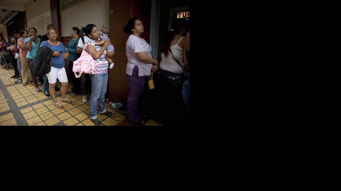 
Milagro Alvarez holds her 5-month-old daughter as she waits in line outside a pharmacy in hopes of buying disposable diapers in downtown Caracas. Diapers are rationed. Falling oil prices are causing more misery to millions of Venezuelans, whose country depends almost exclusively on oil revenue. 

