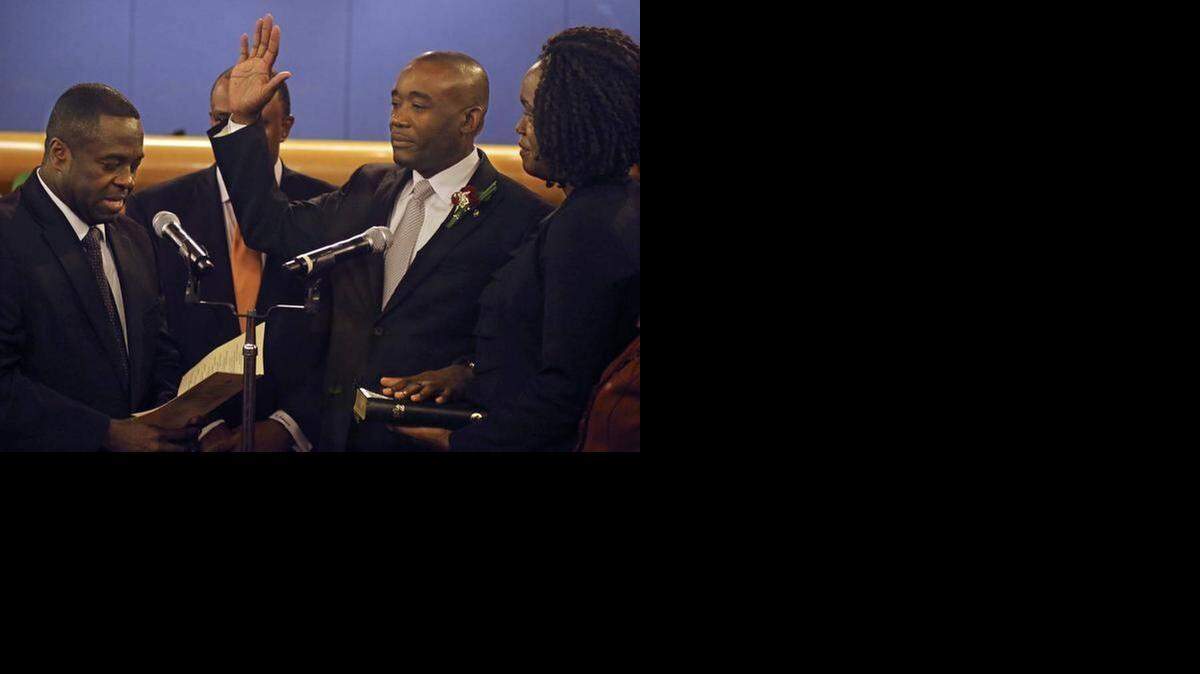 
Miami-Dade Commissioner Jean Monastime was sworn in as the board’s new chairman in January as his wife, Kettia, looks on.
