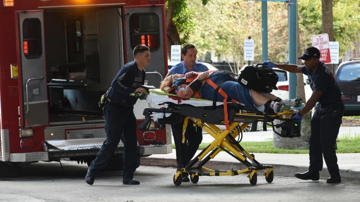 An injured woman is taken into Broward Health Trauma Center in Fort Lauderdale, after a shooting at the Fort Lauderdale-Hollywood International Airport.