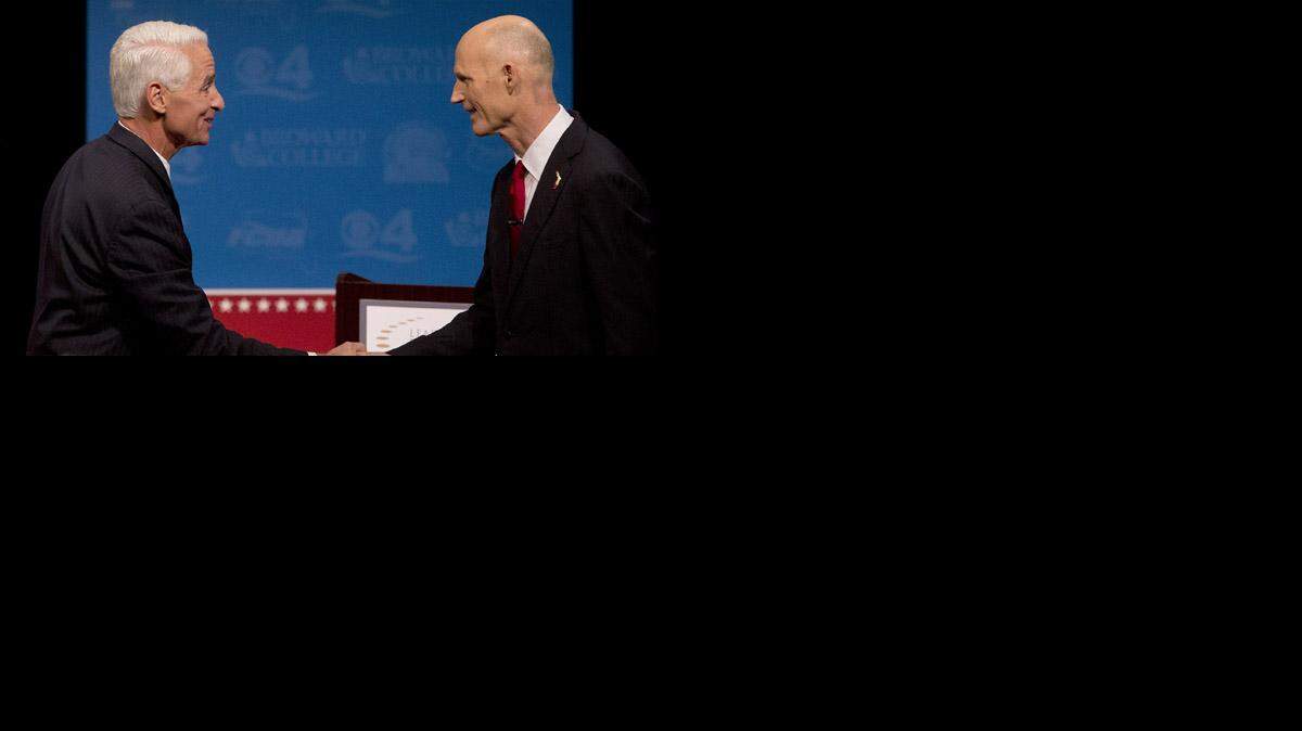 
Charlie Crist, left, and Gov. Rick Scott, shake hands after their second debate.
